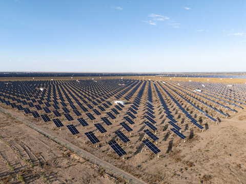 Desert landscape filled with rows of solar panels generating clean energy