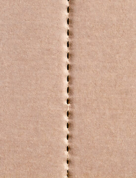 Perforated Tear Line in Corrugated Cardboard Packaging Close Up