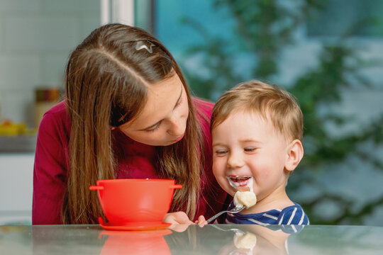 Happy siblings enjoying mealtime together at home.