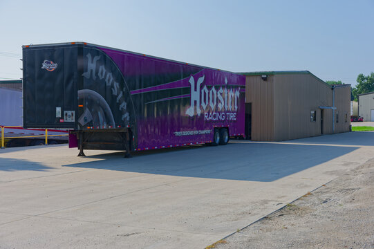 A purple Hoosier Racing Tire semi-trailer parked outside an industrial garage and warehouse, illustrating motorsport logistics, transport and storage. Editorial Use only Plymouth, IN USA Aug 21, 2026.