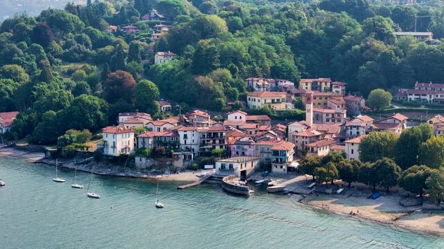 Aerial 4K drone video footage with panoramic view of Cerro on the shores of Lake Maggiore, Italy, capturing the authentic Italian Lakes atmosphere with picturesque waterfront scenery and mountains