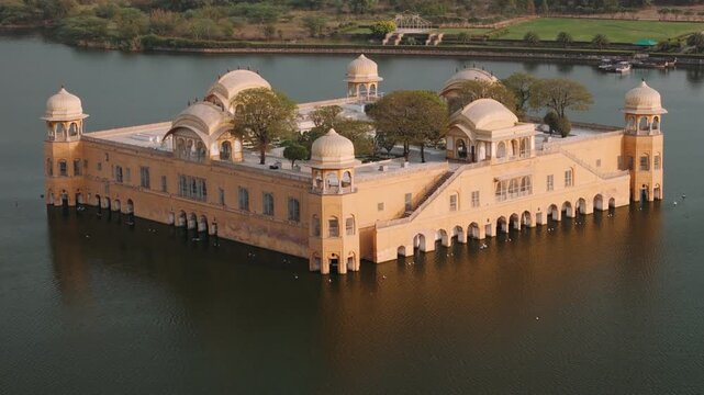 Aerial view of jal mahal water palace on man sagar lake in jaipur, rajasthan, india, during sunset