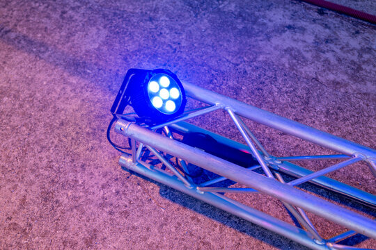 Close-up of a modern stage light mounted on a metal truss structure
