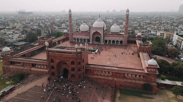 Aerial view of jama masjid mosque in delhi, india revealing the ancient red sandstone architecture and cityscape
