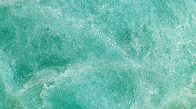 Green amazonite features a soft mottled pattern and muted tones, providing a calming background suitable for various design needs.