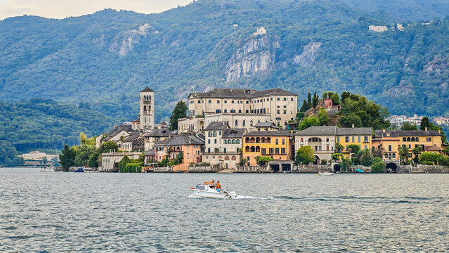 San Giulio Island on Lake Orta, Piedmont, Italy. Aerial panoramic view featuring the historic basilica and picturesque lakeside scenery surrounded by Alpine landscapes