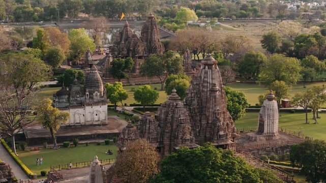 Aerial view of the ancient hindu temples of the khajuraho group of monuments in india surrounded by lush green park