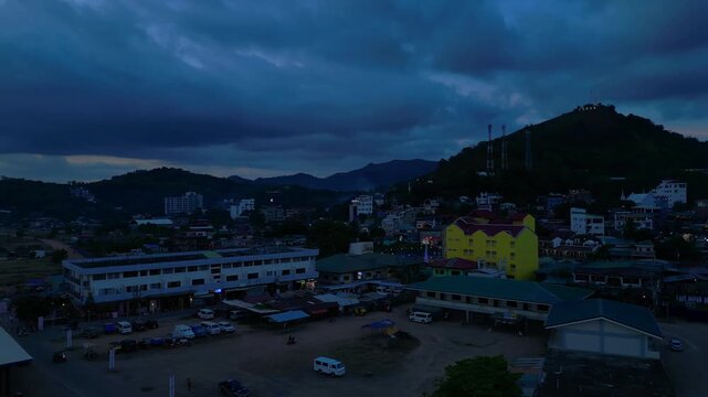Illuminating Coron sign on Mount Tapyas with the town below, showcasing Palawan's popular travel destination at evening. Brilliant aerial view rotation pan to right drone panorama