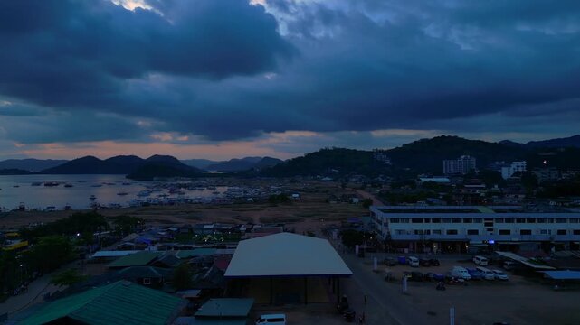Illuminating Coron sign on Mount Tapyas with the town below, showcasing Palawan's popular travel destination at evening. Magic aerial view rotation pan to right drone panorama
