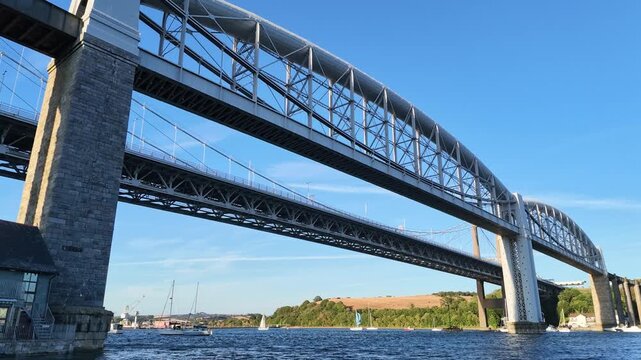 Saltash Cornwall England. 13.08.2026. Video. A grand railway viaduct the Royal Albert Bridge and the Saltash road bridge crossing the Tamar River linking Devon and Cornwall.