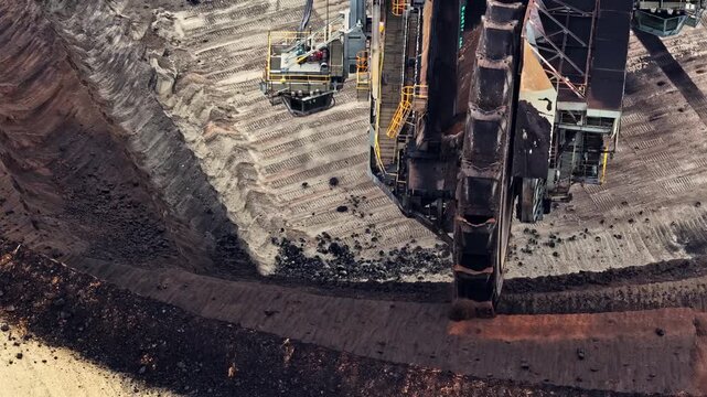 Aerial view of the bucket-wheel excavator at the Garzweiler surface mine, showing deep excavation layers and industrial scale of the site in Juchen, North Rhine-Westphalia, Germany.