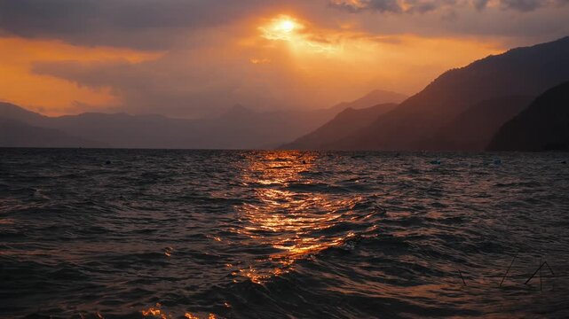 A cloudy sunset on lake Atitl&aacute;n - view from Panajachel, slow motion