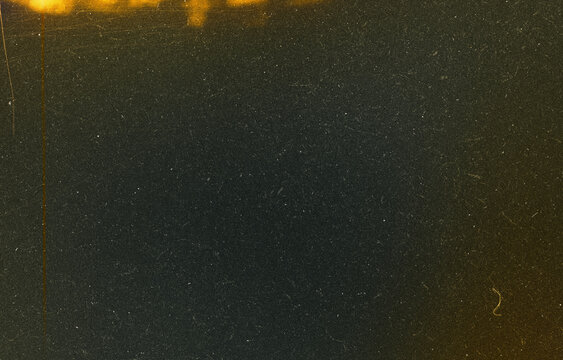 Dark Film Grain Texture with Golden Film Burn, Heavy Dust, and Vertical Edge Scratches on Black Background