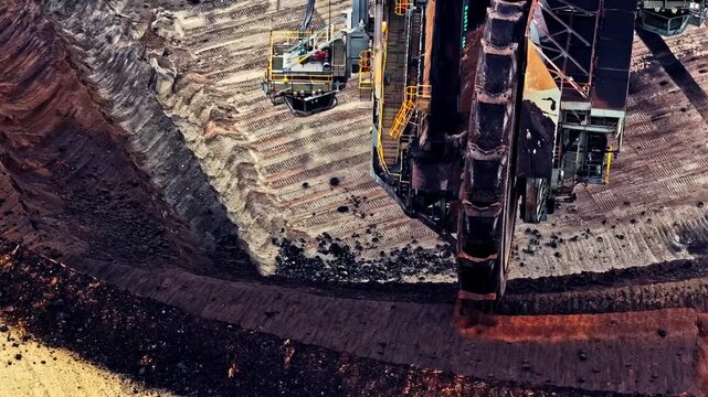 Aerial view of the bucket-wheel excavator at Garzweiler surface mine, showing deep excavation layers and the lignite mining site in Juchen, North Rhine-Westphalia, Germany.