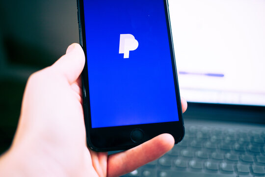person opening paypal app on a phone