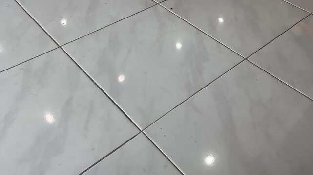 Shiny grey ceramic tile floor texture in modern home interior