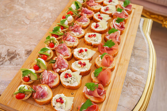 Assorted bruschetta appetizers with meat and fresh vegetables, event catering starter and banquet concept