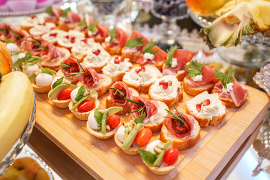 Assorted bruschetta appetizers with meat and fresh vegetables, event catering starter and banquet concept