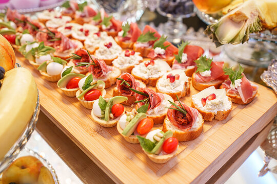 Assorted bruschetta appetizers with meat and fresh vegetables, event catering starter and banquet concept