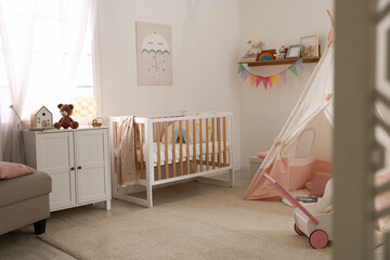 Crib, wigwam and other toys in baby's room. Interior design © New Africa