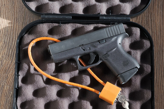 Glock Pistol Resting on Cable Lock in Foam Lined Case