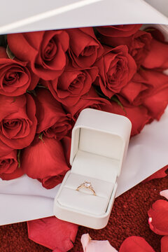 A beautiful Engagement Wedding Ring at a Proposal in front of red bouquet of roses