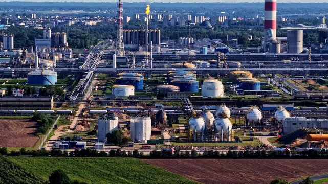 Aerial view of the Orlen Plock Production Plant featuring large industrial storage tanks, complex piping networks, and refinery infrastructure in Plock, Wojewodztwo mazowieckie, Poland.
