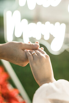 a couple in love holding hands after a marriage proposal