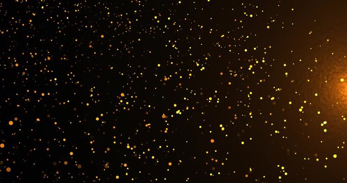 Golden glowing particles float across a dark background, creating an elegant abstract bokeh scene filled with warmth, sparkle, and motion.