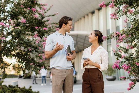 Charming conversation between a Korean woman and a Caucasian man in spring