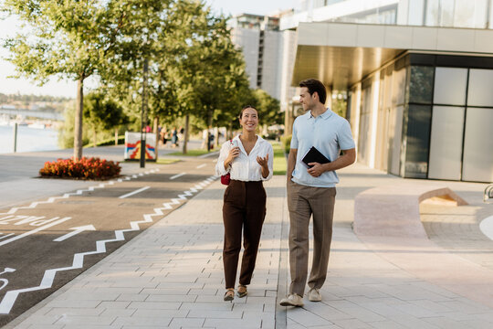 Joyful stroll through a vibrant waterfront area on a sunny afternoon