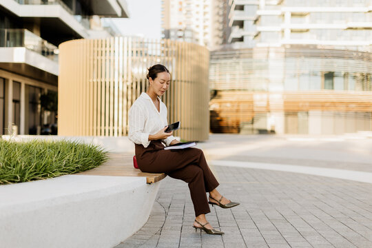 Contemplative moments of a Korean woman in a modern urban setting