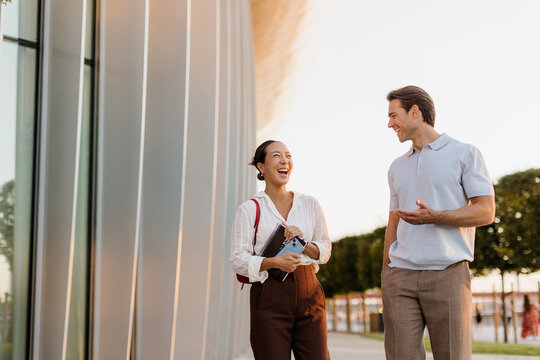 Joyful moments shared between friends during a sunny afternoon in the city