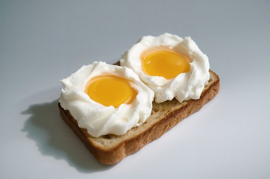Cloud eggs on artisan toast with fluffy whites and bright yolk center