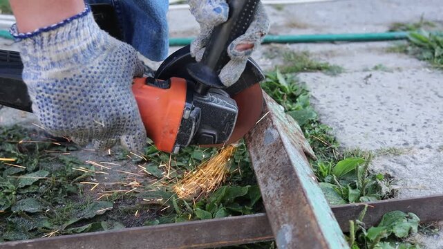 Using a grinder to cut metal in a workshop