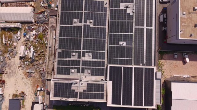 Aerial Top Down View of Solar Panels Installed on Factory Warehouse Roof in Industrial Zone Near Vogosca Bosnia and Herzegovina