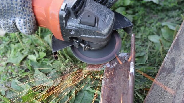 Cutting metal with a grinder in a garden