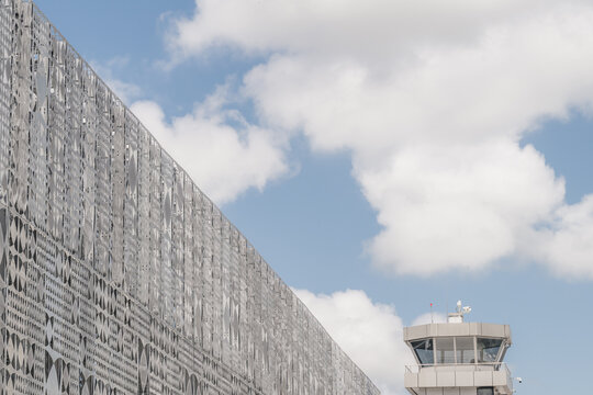 View of the modern patterned facade and control tower of Tirana International Airport in Rinas, Albania.
