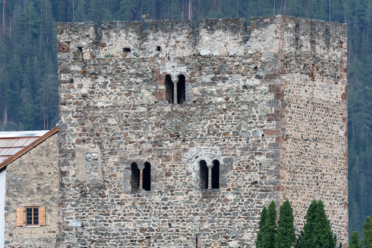 Medieval Stone Castle Tower With Arrow-Slit Windows and Crenellated Battlements in Forest