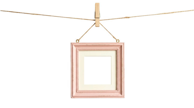 Pink photo frame hanging on twine with clothespeg isolated on white isolated on transparent background