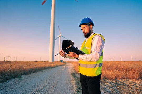 engineer energy man working on a wind turbine farm for sustainable energy production