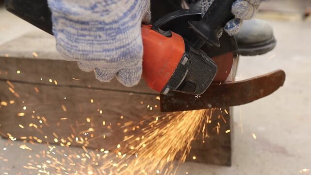 Grinding metal causes sparks in workshop setting