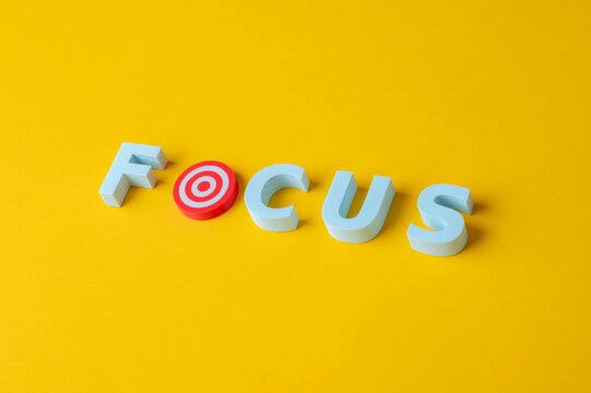 Focus, target and goal achievement concept with bullseye replacing letter O