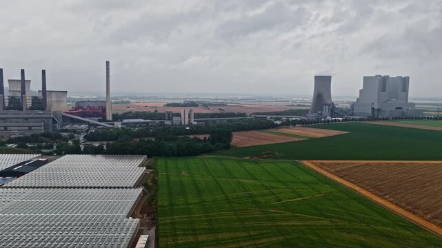 Aerial view of RWE Power AG Kraftwerk Neurath industrial complex with cooling towers and surrounding agricultural fields in Grevenbroich, Nordrhein-Westfalen, Germany.