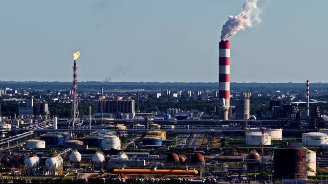Aerial view of Orlen Plock Production Plant with industrial chimneys, storage tanks, and pipelines in Plock, Mazowieckie Voivodeship, Poland.