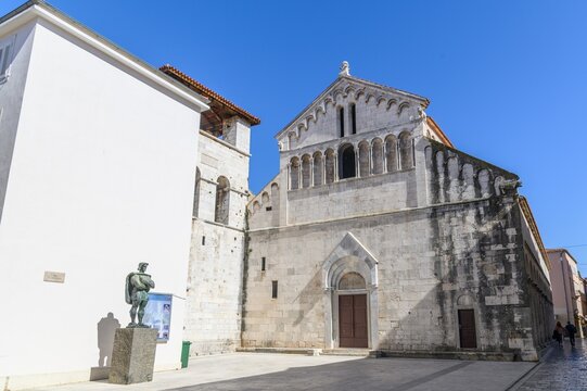Romanesque facade of the church of St Chrysogonus with bronze statue, Zadar, Croatia