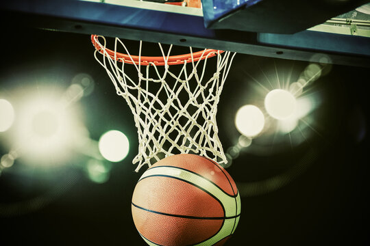 basketball going through the hoop at a sports arena