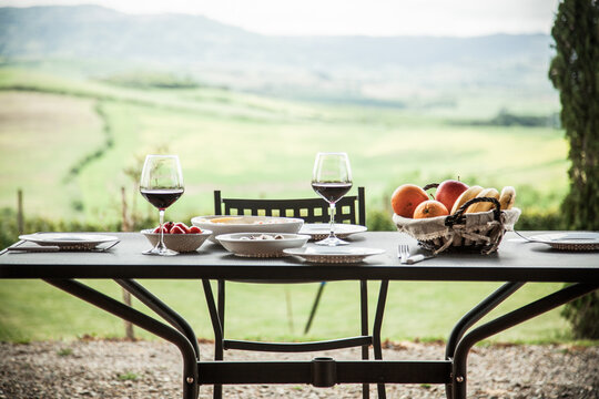 lunch with a view - table against beautiful landscape in Tuscany