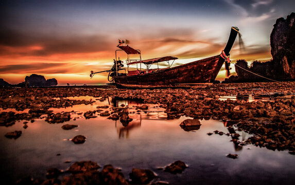longtail boat and amazing sunset on the beach in Krabi  Thailand
