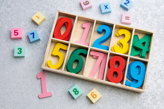 Colorful wooden number blocks in a box on a table ready for kids to learn math